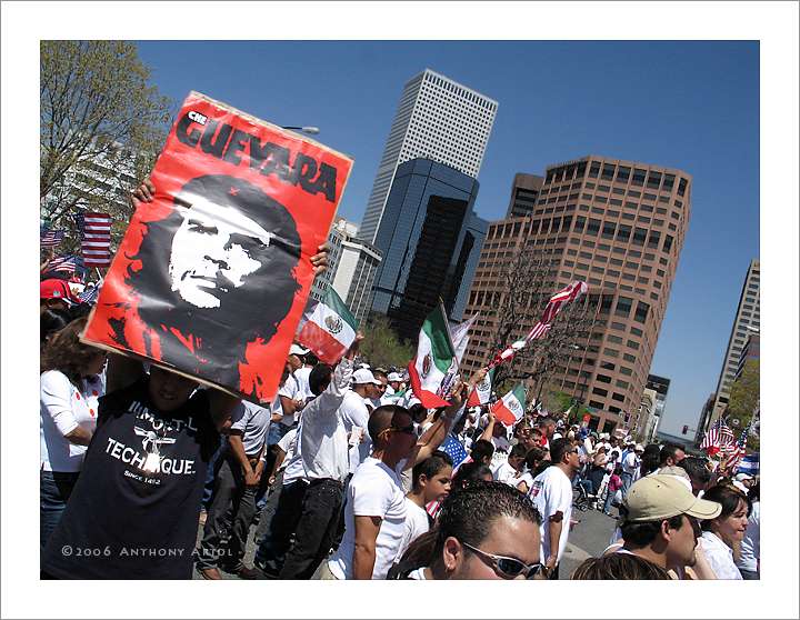 man holding che guevarra poster