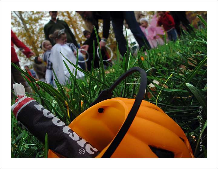 Pumpkin-shaped bucked and children in Halloween costumes
