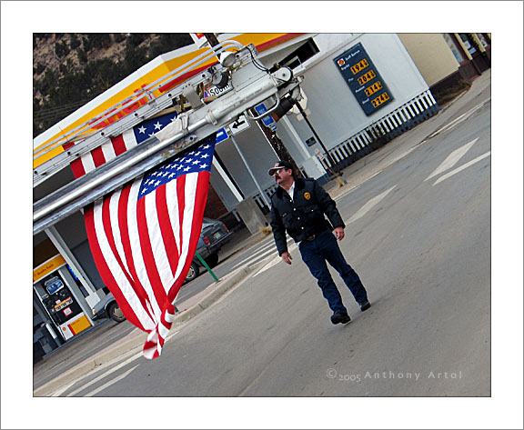 American Flag and Fireman in front of Gas Station